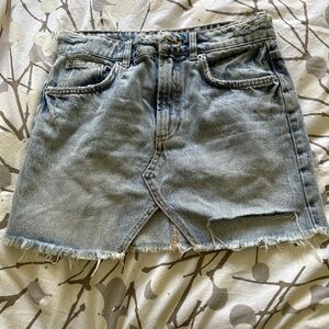Ripped denim skirt.